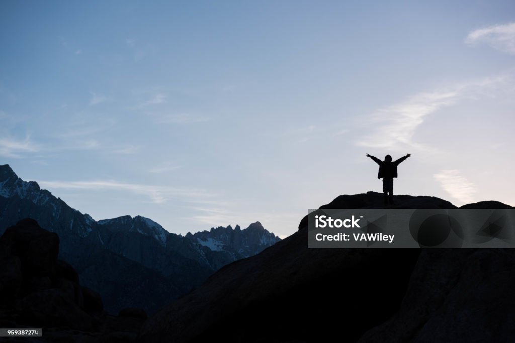 Embracing peace, strength and beauty in the mountains Child camping in the desert in California at the base of Mt Whitney Adventure Stock Photo