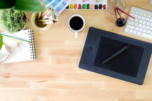 istock Artist workspace top view with digital tablet and creative accessory on wooden table. 959394476