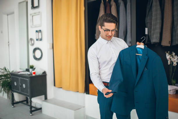 istock Buying new suit in boutique 959394534