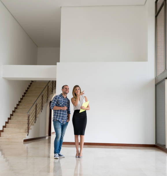 istock Real estate agent showing a property to man 959398630