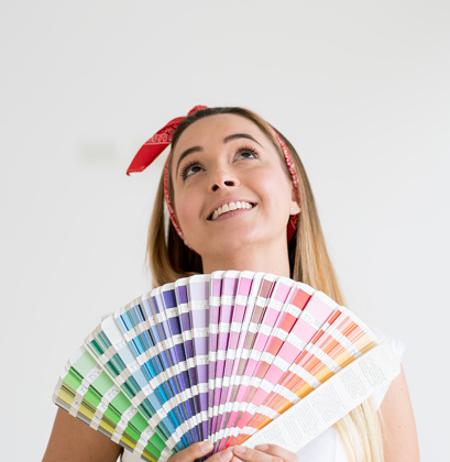 Thoughtful woman working on a housing project and choosing a color to paint the walls - interior design concepts