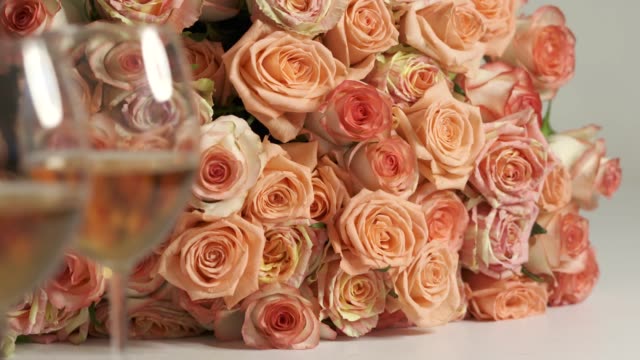 Dolly: Two glasses of wine and extra large bouquet of pink roses