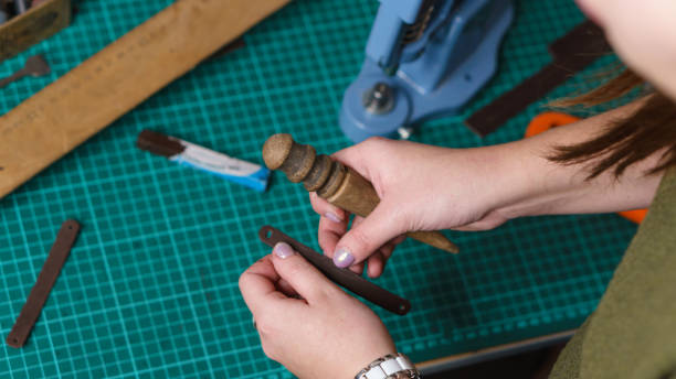 istock Tanner treats edges of leather 959414980