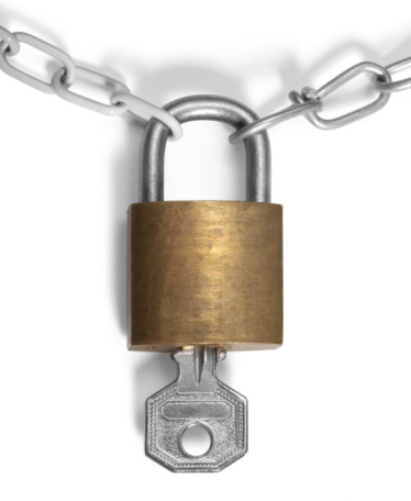 studio photography of a padlock and chains isolated on white with shadow and clipping path