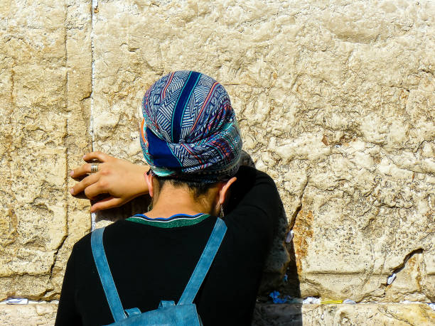 Jerusalem Israel May 14, 2018 Unknown woman praying front the Western wall in the old city of Jerusalem in the evening