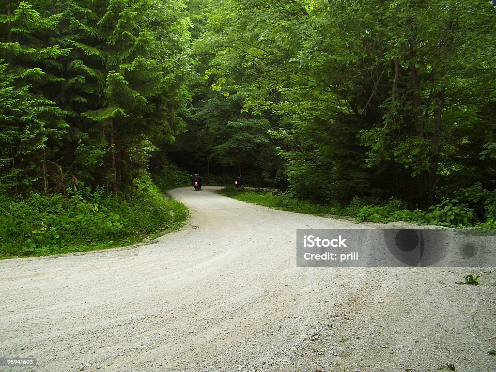 motor biking backside of two distant motor bikes on gravel road at summer time Activity Stock Photo