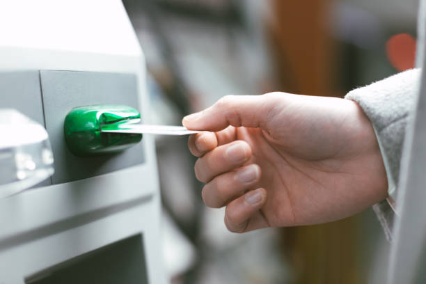 istock man put credit card into ATM 959418772