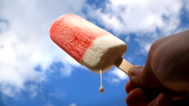 SLO MO Strawberry Ice Cream Melting on Blue Sky Background