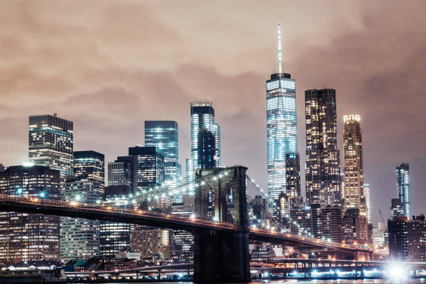 istock Manhattan skyline and Brooklyn bridge in NYC at night 959428964
