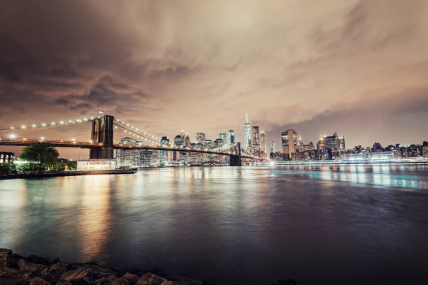 NY Brooklyn Bridge at night with Manhattan skyline in background