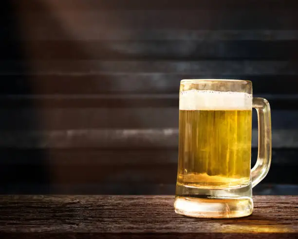Glass of Beer on Wooden Table in Pub or Restaurant