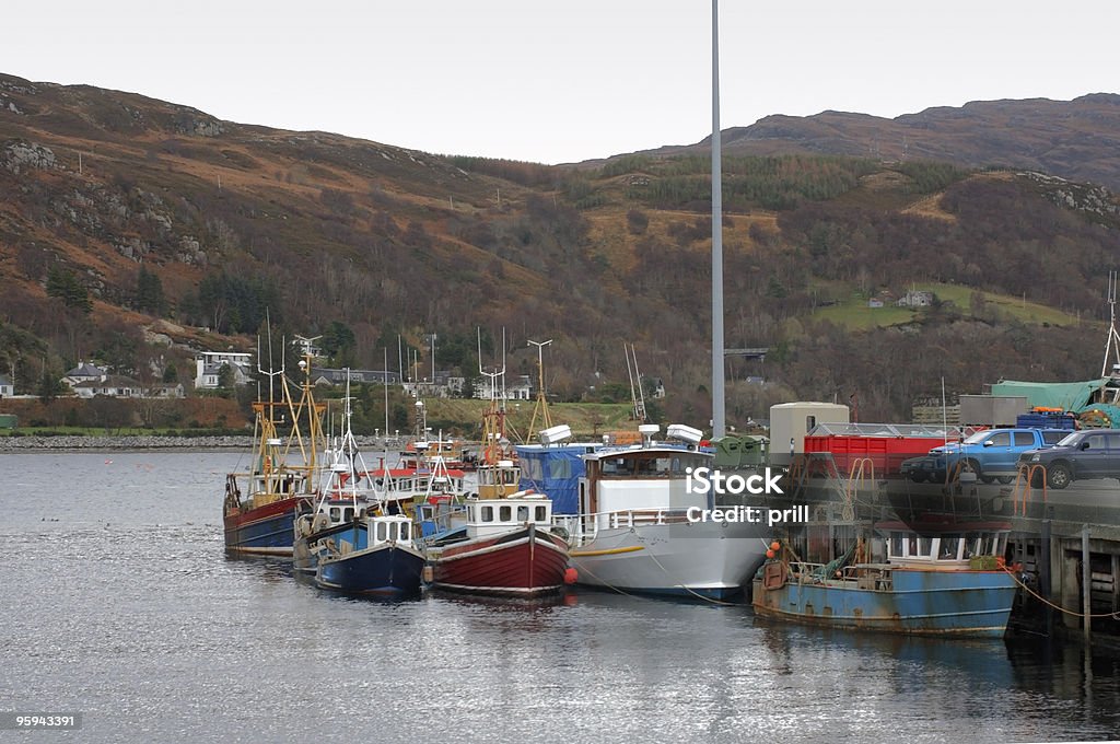 fishing boats near Ullapool small boats on a pier near Ullapool in Scotland Anchored Stock Photo