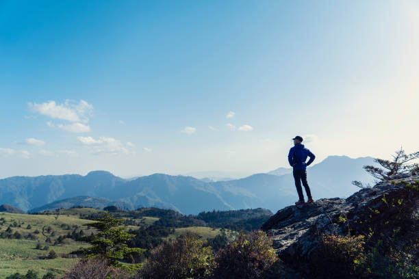 istock A man hiking with a view from the rock 959438370