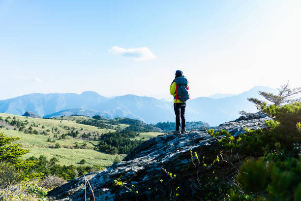 istock A woman hiking with a view from the rock 959438376