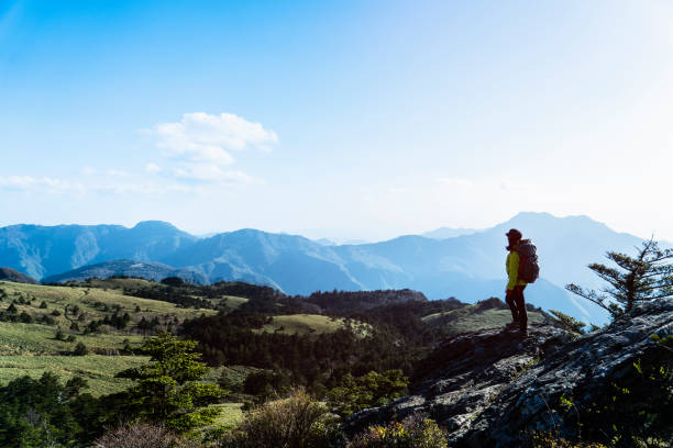 istock A woman hiking with a view from the rock 959438378