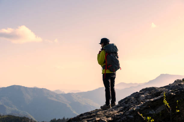 istock A woman hiking with a view from the rock 959438382