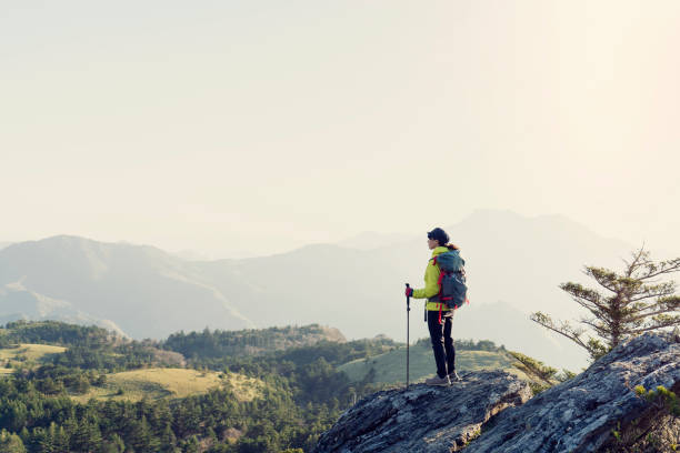 A woman hiking with a view from the rock
