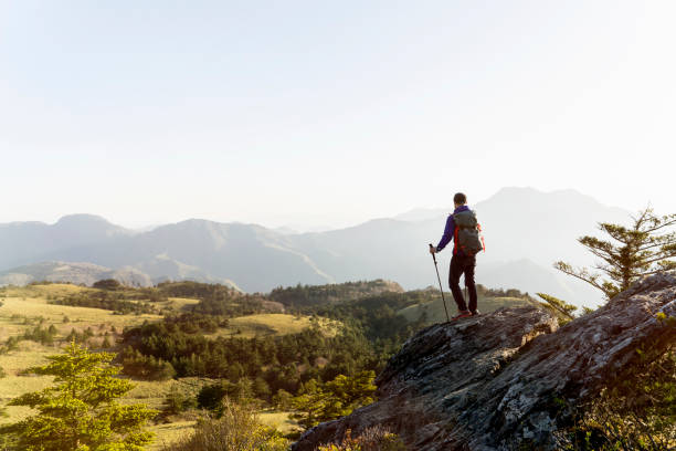 istock A man hiking with a view from the rock 959438442