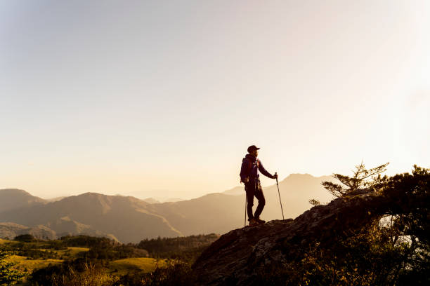 istock A man hiking with a view from the rock 959438456