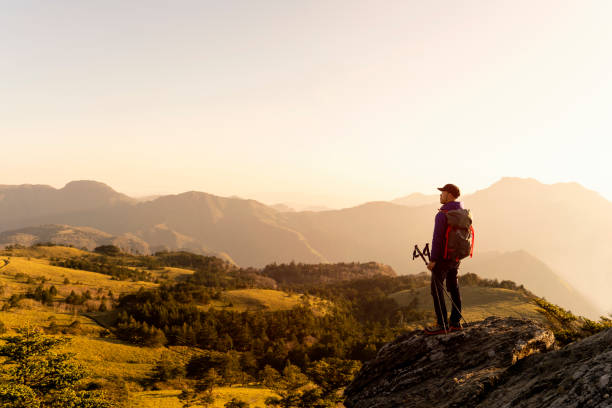 istock A man hiking with a view from the rock 959438476
