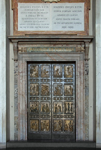 the famous Holy Door at St. Peter´s Basiica in Rome (Italy) with rich adornment and decorations