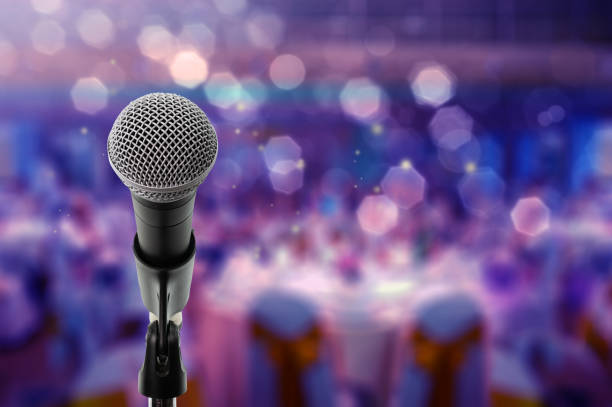 Close up microphone on stage in Ball room Close up microphone  on stage in Bdynamicall room. live performance stock pictures, royalty-free photos & images