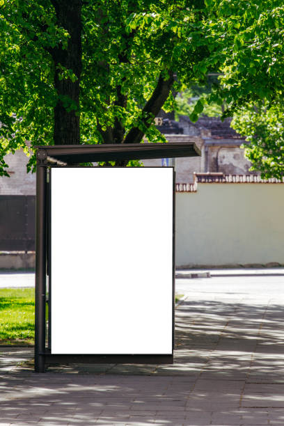 istock Vertical blank white billboard at bus stop on city street. 959443330