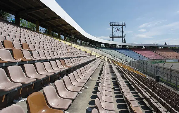 tribune detail of a racetrack named "Hockenheimring" in Southern Germany, with lots of chair rows in sunny ambiance