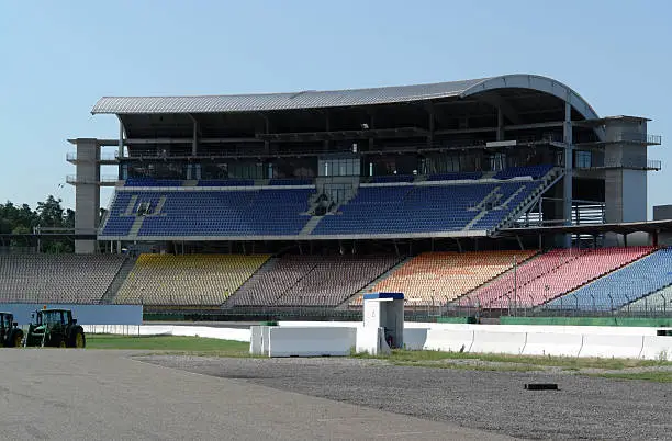 tribune and multi colored seat places at a racetrack named "Hockenheimring" in Southern Germany in sunny ambiance