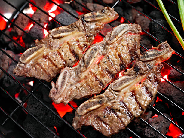 Short Rib on Charcoal Grill with Roasted Garlic.