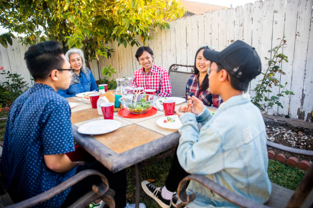 istock Teenage Boy Telling Story at Dinner Table 959451606