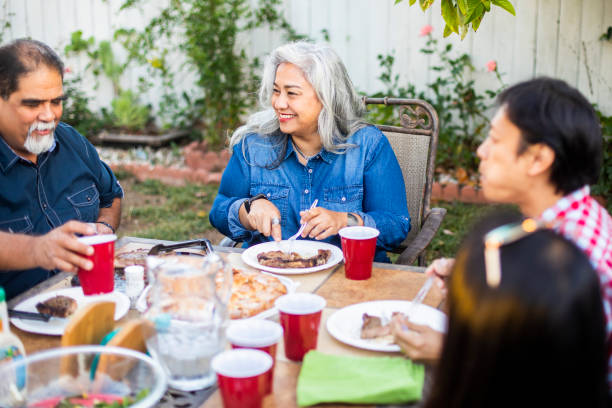 istock Senior Mexican Woman Laughs at Dinner 959451882