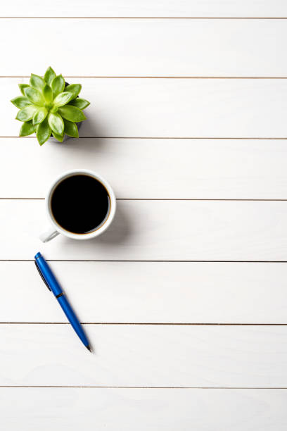 istock Office desktop with cup of coffee and a pen 959453080