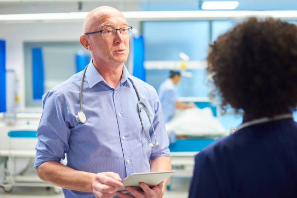 istock senior doctor with nurse 959453430