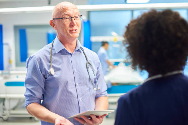 istock senior doctor with nurse 959453614