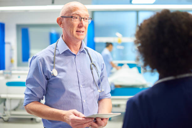 istock senior doctor with nurse 959453718