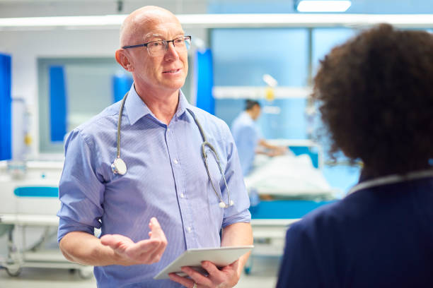 istock senior doctor with nurse 959453842