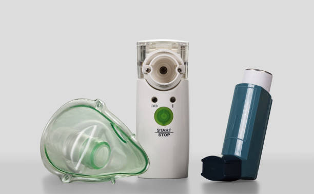 istock Ultrasonic mesh nebulizer and portable pocket inhalator, child mask, on gray 959457872