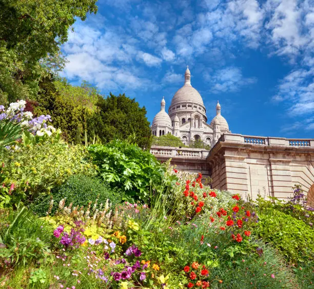 Photo of Spring flowers in the garden in front of Sacre Coeur Cathedral in Paris