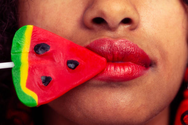 istock Red lips and sweet watermelon lollipop. 959459422