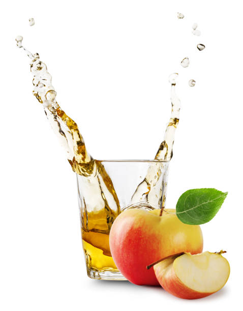 istock Glass of apple juice with splash and apples 959464098