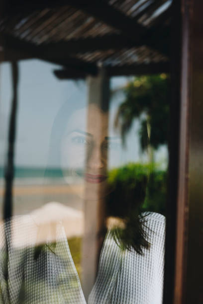 istock Woman looking out her hotel room window 959467342