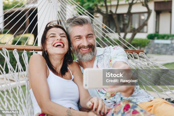 Couple Taking A Selfie While On Vacation Stock Photo - Download Image Now - Couple - Relationship, Mature Couple, Summer