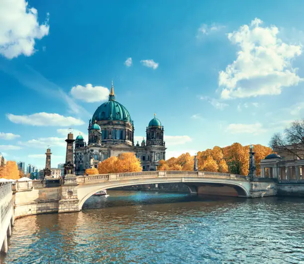 Berlin Cathedral with a bridge over Spree river in Autumn, panoramic toned image