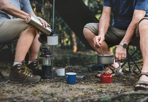 Mature man cooking at a campsite