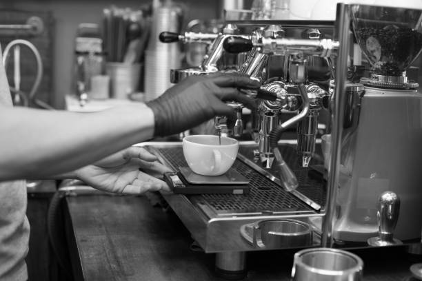 istock Barista using machine for make coffee at cafe. black and white tone. 959477930
