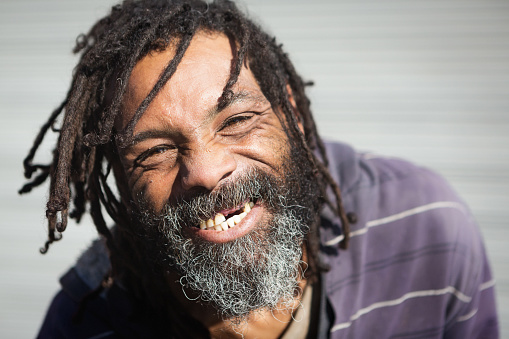 Happy Rastafarian with missing teeth.