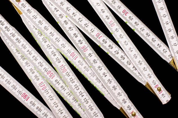 White carpenter's ruler isolated on the black background
