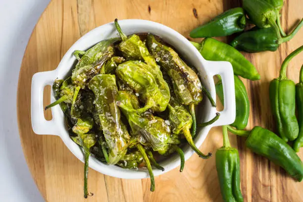 Pimientos de Padron. Padron Green Peppers in White Bowl.