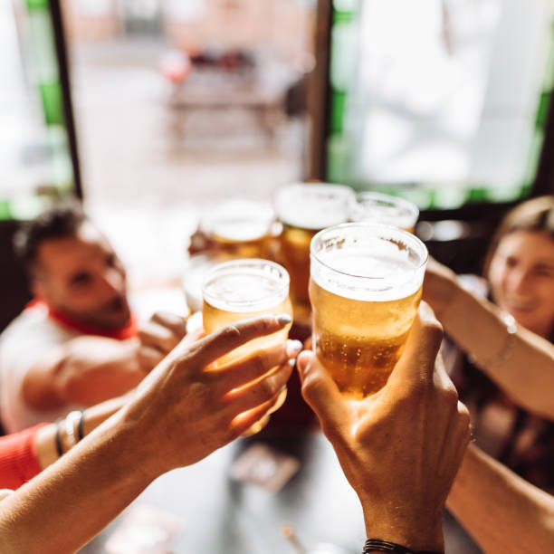 istock group of friends toasting the beer in a pub 959482726